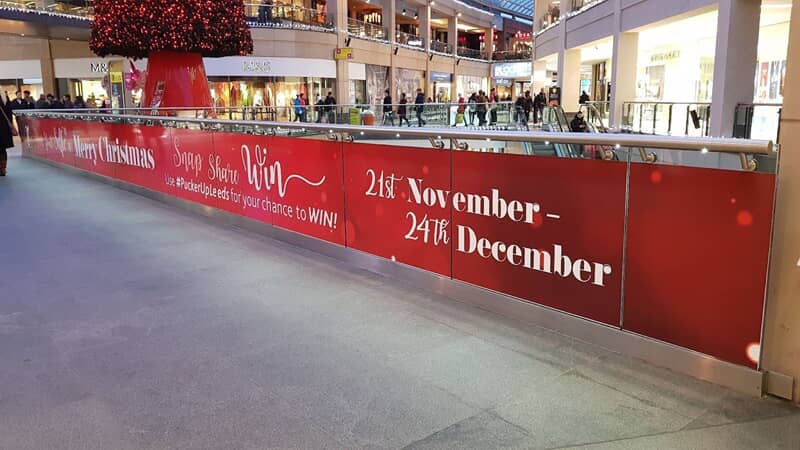 An image of a holiday banner in a mall.